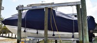 Photo of Boston Whaler Outrage 280 20xx TTopCover™ T-Top boat cover Sand Bags On Lift, viewed from Port Side 
