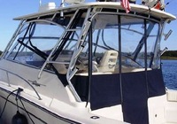 Photo of Grady White Express 330, 2007 Front Visor, Side Curtains, Aft-Drop-Curtain Sunbrella Fabric, viewed from Port Rear 
