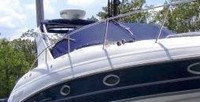 Photo of Larson Cabrio 330, 2007: Factory Arch Bimini Top in Boot Arch Connections Cockpit Cover, viewed from Starboard Front 
