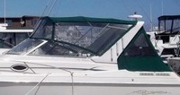 Photo of Monterey 296 Cruiser Under Arch, 1999: Bimini Top, Visor, Side Curtains, Camper Top, Camper Side and Aft Curtains Sunbrella Hunter Green Tweed, viewed from Port Side 