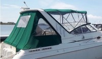 Photo of Monterey 296 Cruiser Under Arch, 1999: Bimini Top, Visor, Side Curtains, Camper Top, Camper Side and Aft Curtains Sunbrella Hunter Green Tweed, viewed from Starboard Rear 