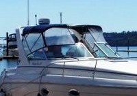 Photo of Rinker 270 Fiesta Vee, 2001: Factory OEM Bimini Top, Connector open, Side Curtains, viewed from Starboard Front 