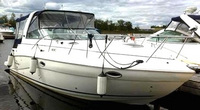 Photo of Rinker 320 Express Cruiser, 2006: Bimini Connection Connector, Side Curtains, Camper Top Connection, Side Aft Curtains, viewed from Starboard Front 